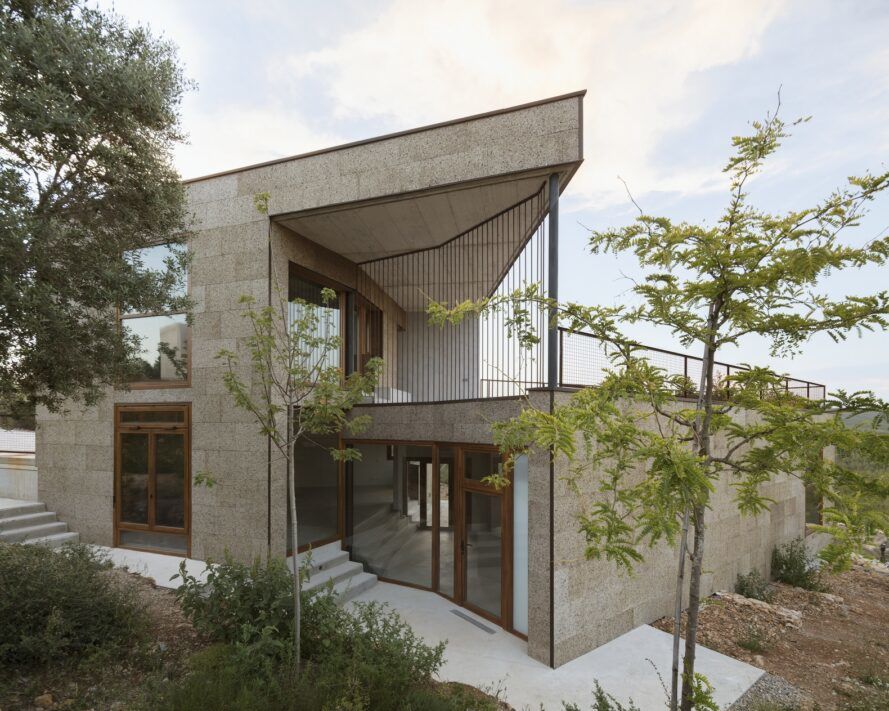 A two story house that looks like its built from stone