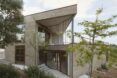 A two story house that looks like its built from stone