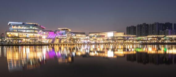 The mall sprawling a stretch of distance with its lights reflecting on the river in front of it