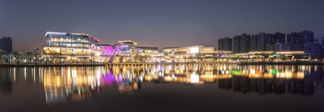 The mall sprawling a stretch of distance with its lights reflecting on the river in front of it