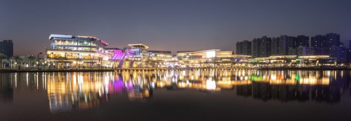 The mall sprawling a stretch of distance with its lights reflecting on the river in front of it
