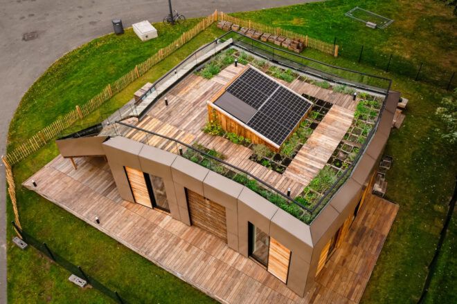 Top view looking down to the rooftop garden with wooden decking and raised solar panels