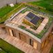 Top view looking down to the rooftop garden with wooden decking and raised solar panels