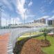 A curved walkway that is risen above a grassy area