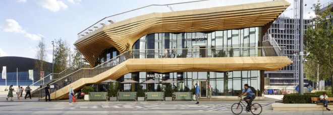 The exterior of a two-level wood pavilion.