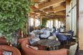An indoor seating area with wood ceiling.