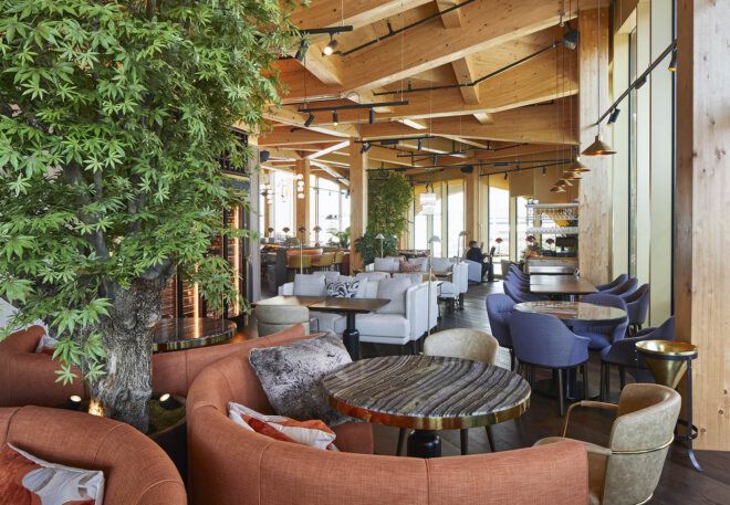 An indoor seating area with wood ceiling.