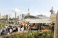A rooftop patio with many people gathered.