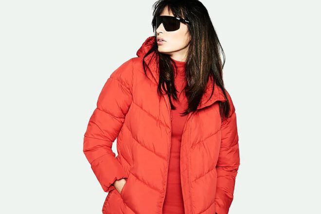 A person in a red-orange puffer jacket.