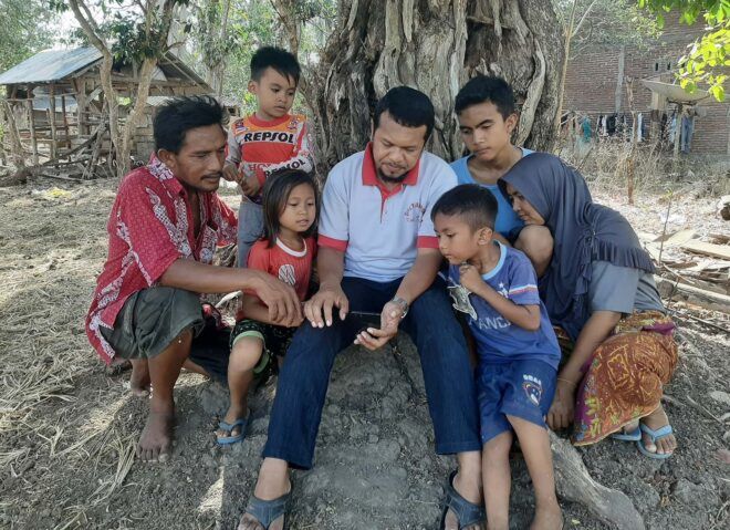 A Dompu farmer and family testing the app.