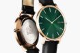 A watch with a green dial.