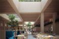 An indoor cafeteria space with a skylight bringing in natural light.