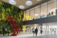 The lobby of a LEGO factory, with a large red LEGO dinosaur statue.