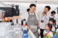 A man showing little kids how a machine works