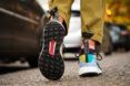The black tread of a pair of multicolored shoes.