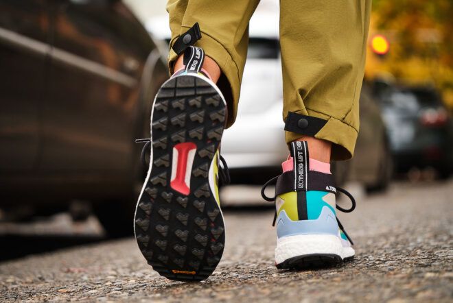 The black tread of a pair of multicolored shoes.