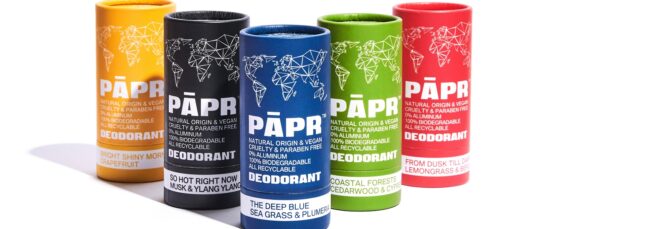 Four tubes of deodorant, from left to right, yellow, black, blue, green and red