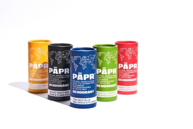 Four tubes of deodorant, from left to right, yellow, black, blue, green and red