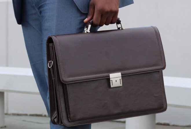 A hand holding a briefcase.