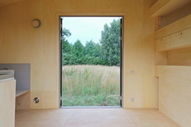 A doorway from within the wooden interior