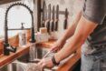 A person is washing something in a sink