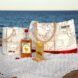 A beverage bucket, tote bag, bottle of alcohol and a cup of alcoholic beverage