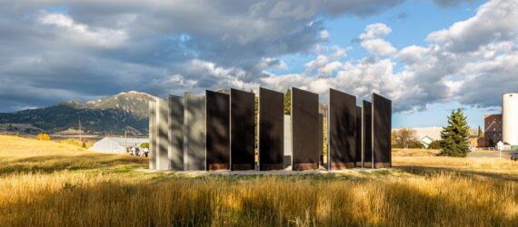 Wooden slats standing in a circle on a hill
