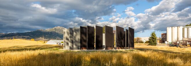 Wooden slats standing in a circle on a hill