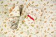 Different size gifts wrapped in a white patterned wrapping paper