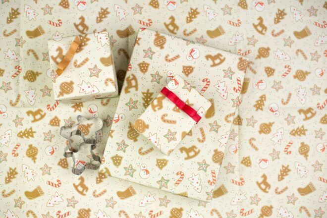 Different size gifts wrapped in a white patterned wrapping paper