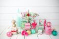 Multicolor gifts and ornaments against a white wood background