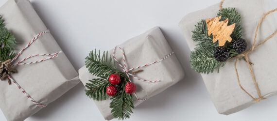 Three wrapped gifts against a white background.