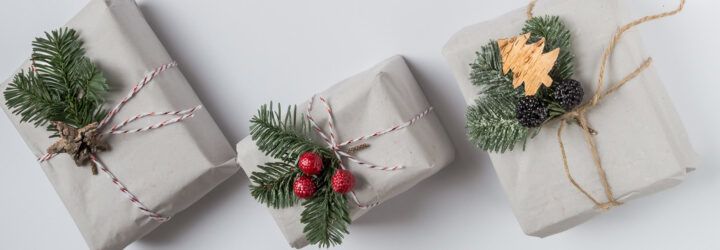 Three wrapped gifts against a white background.