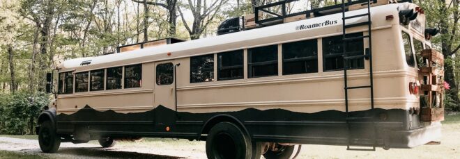 A school bus sits in a forest