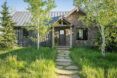 The exterior of a wood and stone cabin.