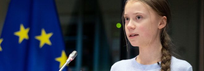 Greta Thunberg looking to the left.