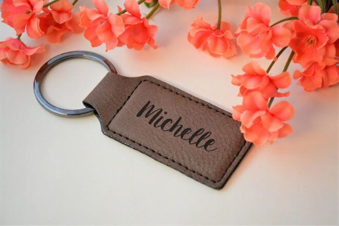 A leather keychain engraved with the name Michelle.