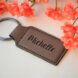 A leather keychain engraved with the name Michelle.