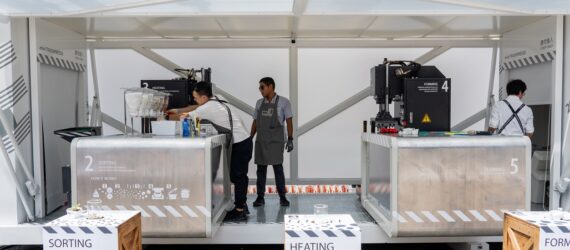 A rectangular structure with people working inside