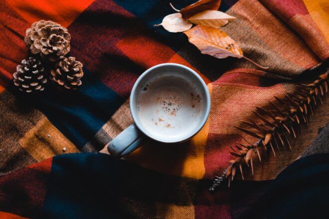 A mug of hot chocolate sits on a blanket