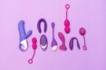 A collection of sex toys against a purple background