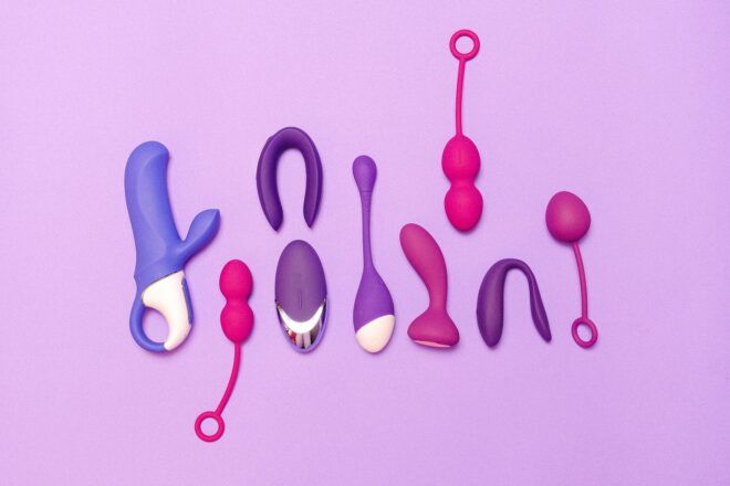 A collection of sex toys against a purple background