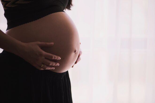The belly of a pregnant person