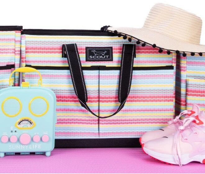 A pink striped bag with a straw hat and pink sneakers
