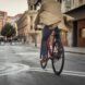 A person riding a bike down the street.
