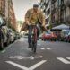 A person riding a bike down the street.