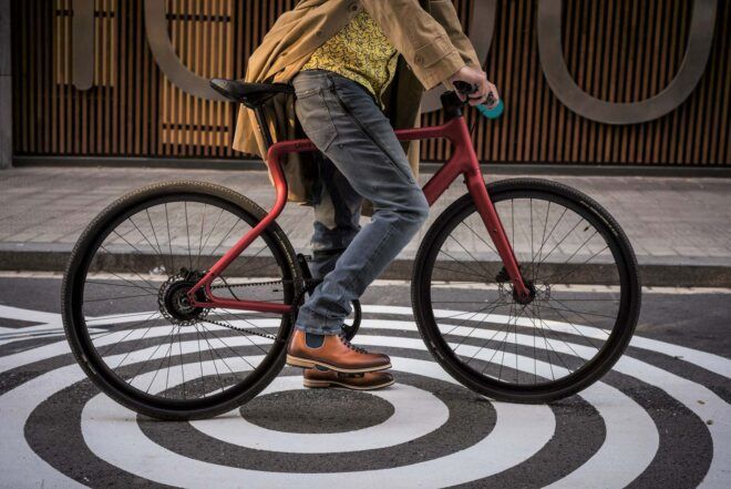 A sideview of a person on a bike.