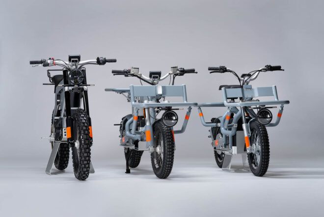 Three e-bikes against a gray background.