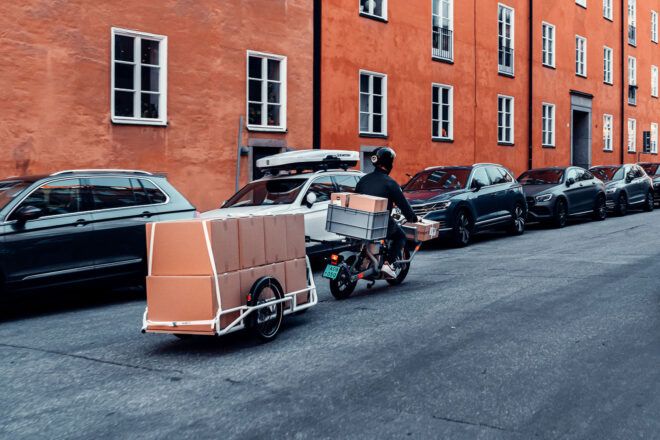 A delivery bike driving down the road.