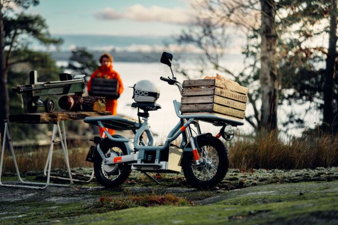 A moped parked on the grass.